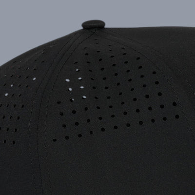 Side close-up view of a black 5-panel cap against a plain gray background