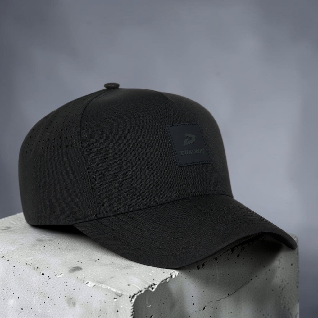 Black cap on a concrete surface with a gray background