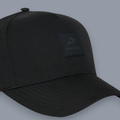 Three-quarter view of a blank black 5-panel cap against a gray background