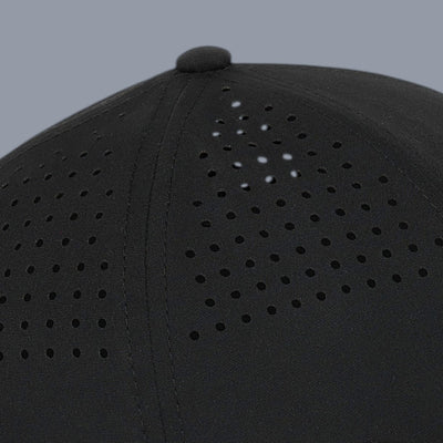 Side close-up view of a black baseball cap against a plain gray background