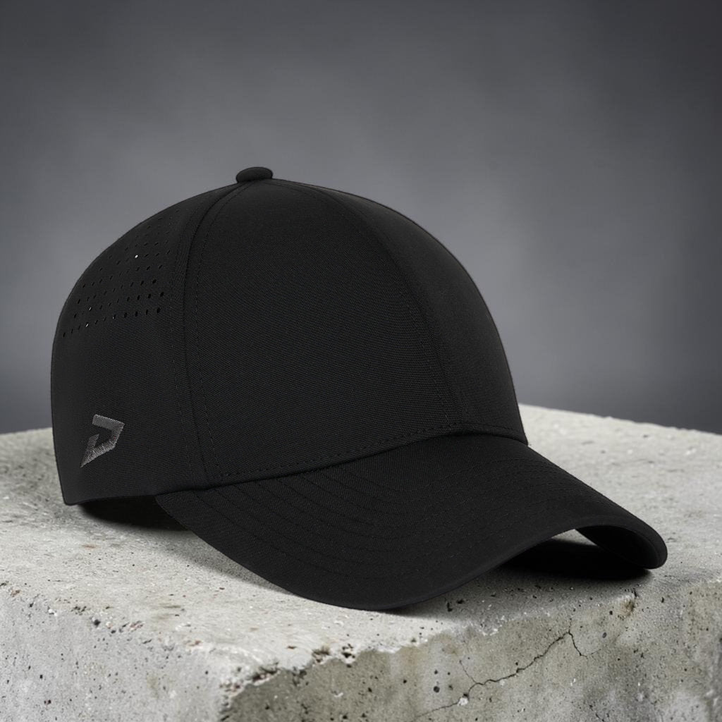 Black baseball cap on a concrete surface with a gray background